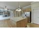 Kitchen featuring a granite island, stainless steel appliances, and light wood cabinetry at 3835 Greenside Ct, Dacula, GA 30019