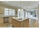 Open kitchen featuring an island, stainless dishwasher, and light wood cabinets at 3835 Greenside Ct, Dacula, GA 30019