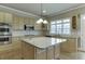 Large kitchen island with stainless steel appliances, light cabinets, and granite countertops at 3835 Greenside Ct, Dacula, GA 30019