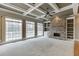 Inviting living room with a stone fireplace, coffered ceiling, and large windows providing natural light at 3835 Greenside Ct, Dacula, GA 30019