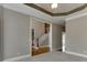 Living room area showcasing the stair case, trey ceilings, and decorative trim at 3835 Greenside Ct, Dacula, GA 30019
