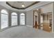 Sitting room with arched windows, trey ceilings, and decorative trim at 3835 Greenside Ct, Dacula, GA 30019