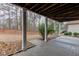 Covered patio provides a relaxing retreat with views of the lush wooded backyard at 3835 Greenside Ct, Dacula, GA 30019