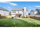 Large backyard with an expansive lawn, a covered patio, and mature trees at 5466 Vinings Lake Way, Mableton, GA 30126