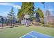 Community basketball court, fenced and surrounded by mature trees, providing a private and active space at 5466 Vinings Lake Way, Mableton, GA 30126