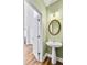 The powder room has a pedestal sink with a modern light fixture and mirror at 5466 Vinings Lake Way, Mableton, GA 30126