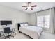 Cozy bedroom features a ceiling fan, plush carpet, and a sunny window with elegant curtains at 5466 Vinings Lake Way, Mableton, GA 30126