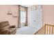 Charming bedroom with a chair, framed artwork, and a closet with traditional doors at 5466 Vinings Lake Way, Mableton, GA 30126