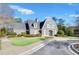 Community clubhouse with a well-manicured lawn, professional landscaping, and a circular driveway at 5466 Vinings Lake Way, Mableton, GA 30126