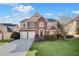 Charming two-story brick home with a well-manicured lawn and attached two-car garage at 5466 Vinings Lake Way, Mableton, GA 30126