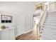 Inviting foyer featuring wood floors, a staircase, and neutral decor at 5466 Vinings Lake Way, Mableton, GA 30126