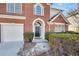 Close-up of the front door framed by brick, with an attached two-car garage at 5466 Vinings Lake Way, Mableton, GA 30126