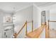 Second floor hallway features hardwood floors, white railings, and views to the entry at 5466 Vinings Lake Way, Mableton, GA 30126
