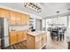 Open kitchen offers stainless appliances, an island, and a view of the living room at 5466 Vinings Lake Way, Mableton, GA 30126