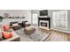 Bright living room features a fireplace with a marble surround and hardwood floors at 5466 Vinings Lake Way, Mableton, GA 30126