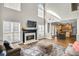 This cozy living room has a fireplace, hardwood floors, and large windows at 5466 Vinings Lake Way, Mableton, GA 30126