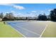 Community tennis courts with bright blue and green surfaces, surrounded by mature trees on a clear day at 5466 Vinings Lake Way, Mableton, GA 30126