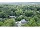 Aerial view of a property surrounded by lush green trees, offering privacy and a serene environment at 2116 Strasburg Ct, Dunwoody, GA 30338