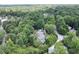Aerial view showcasing a house nestled within a dense forest, offering unparalleled privacy and seclusion at 2116 Strasburg Ct, Dunwoody, GA 30338