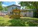 Spacious backyard with a raised deck, covered patio, and ample lawn space, perfect for outdoor activities at 2116 Strasburg Ct, Dunwoody, GA 30338