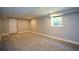 Finished basement showcasing neutral carpet and a window letting in natural light at 2116 Strasburg Ct, Dunwoody, GA 30338