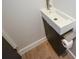 Small sink and cabinet in bathroom features toilet paper holder at 2116 Strasburg Ct, Dunwoody, GA 30338