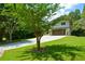 Landscaped front yard leads up to the home with a large driveway and modern features at 2116 Strasburg Ct, Dunwoody, GA 30338
