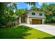 Charming two-story home with landscaped yard, modern front door, and attached garage at 2116 Strasburg Ct, Dunwoody, GA 30338