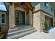 Close-up of the modern front door with stone accents and stylish exterior lighting at 2116 Strasburg Ct, Dunwoody, GA 30338