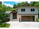 Charming two-story home with a stone and wood facade, modern garage door and a well-manicured lawn at 2116 Strasburg Ct, Dunwoody, GA 30338