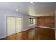 Bright living room with hardwood floors and access to a backyard space via sliding doors at 2116 Strasburg Ct, Dunwoody, GA 30338