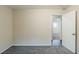 Bedroom with a carpeted floor and a view into an adjoining room with wood-look flooring at 2916 Lloyd Rd, Decatur, GA 30034