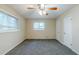 Spacious bedroom featuring a ceiling fan, plush carpeting, and a bright window at 2916 Lloyd Rd, Decatur, GA 30034
