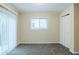 The bedroom includes plush carpeting, a sliding glass door and a closet for easy storage at 2916 Lloyd Rd, Decatur, GA 30034