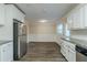Spacious kitchen featuring stainless steel appliances, granite counters, and a dining area with wainscoting at 2916 Lloyd Rd, Decatur, GA 30034