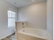 Clean, well-lit bathroom features a white tub-shower and a window providing natural light at 324 Shine Dr, Stockbridge, GA 30281