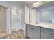 Bright bathroom with double vanity, shower, wood-look tile and modern finishes at 324 Shine Dr, Stockbridge, GA 30281