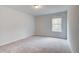 Bedroom featuring neutral carpet, a window letting in natural light, and light-colored walls at 324 Shine Dr, Stockbridge, GA 30281