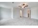 Bright bedroom features carpet, light walls, a ceiling fan and ensuite bathroom access at 324 Shine Dr, Stockbridge, GA 30281