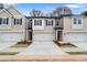 Charming townhome featuring a neutral color palette, two-car garage, and manicured front yard at 324 Shine Dr, Stockbridge, GA 30281
