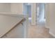 Upstairs hallway with neutral carpet, white trim, and doors leading to bedrooms and baths at 324 Shine Dr, Stockbridge, GA 30281