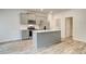 Modern kitchen featuring stainless appliances, quartz countertops, and a convenient center island at 324 Shine Dr, Stockbridge, GA 30281