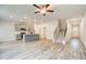Open-concept living room featuring stairs to upper level and kitchen with large center island at 324 Shine Dr, Stockbridge, GA 30281