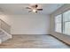 Bright living room featuring hardwood floors, a ceiling fan, and stairs to the upper level at 324 Shine Dr, Stockbridge, GA 30281