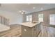 Stylish kitchen featuring a breakfast bar overlooking a large living area with natural light at 324 Shine Dr, Stockbridge, GA 30281