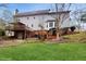Wide backyard showcasing the home's exterior, including a deck, patio, and manicured lawn at 3242 Inns Brook Way, Snellville, GA 30039
