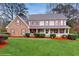 Charming two-story home with brick and siding, complemented by a lush green lawn and mature trees at 3242 Inns Brook Way, Snellville, GA 30039