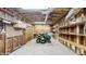 Spacious garage or workshop area featuring ample shelving and a lawn mower at 3242 Inns Brook Way, Snellville, GA 30039