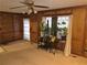 Traditional living room featuring wood paneling, plush carpeting, and natural light at 3242 Inns Brook Way, Snellville, GA 30039