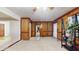 Spacious living room with wood paneling, plush carpeting, and access to outdoor patio at 3242 Inns Brook Way, Snellville, GA 30039